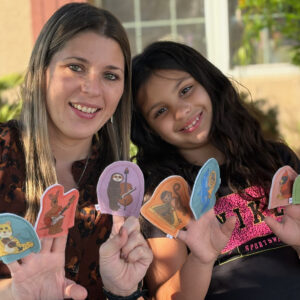 Mother and child playing with finger puppets